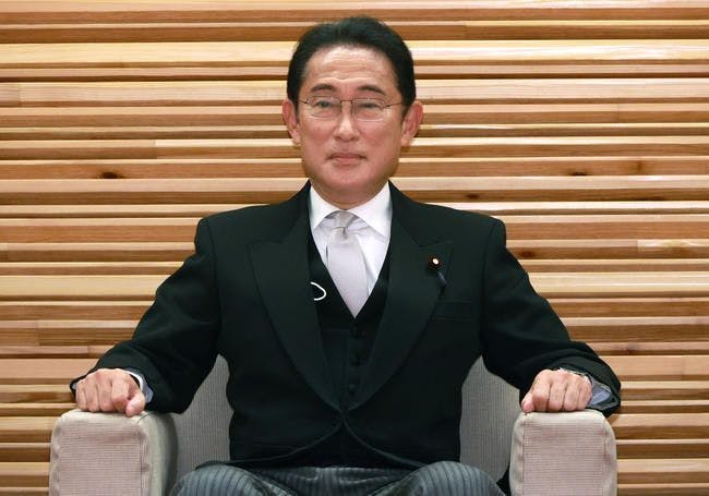prime minister kishida sitting on a chair
